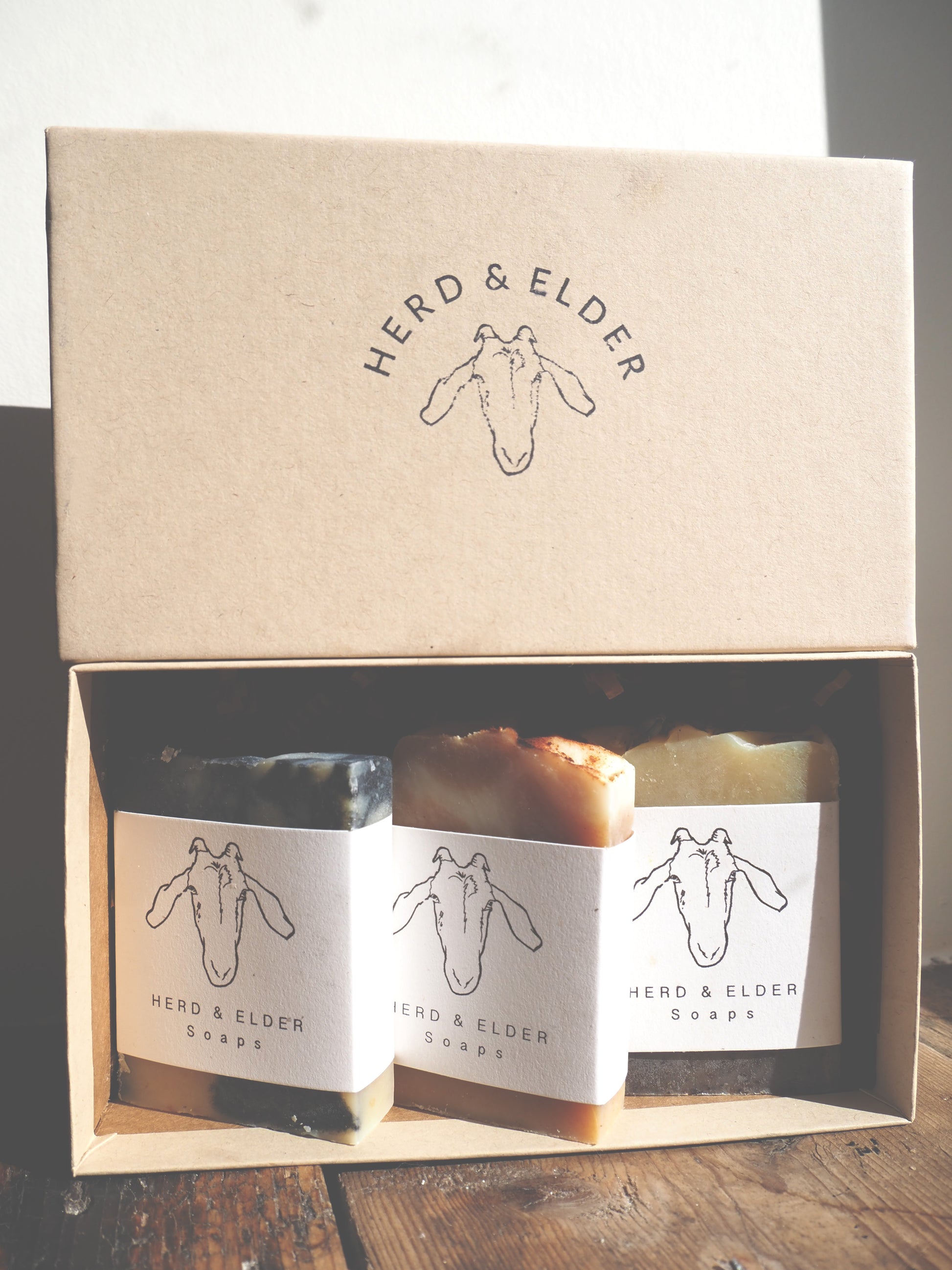 Goat milk soap gift set in eco-friendly Kraft box featuring three artisan bars from Herd & Elder.