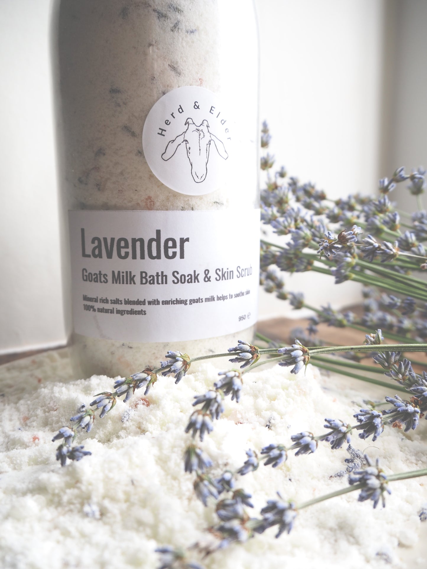 Luxury Goat Milk Bath Salts – Lavender & Botanical Soak with Essential Oils in a glass bottle with lavender flowers.