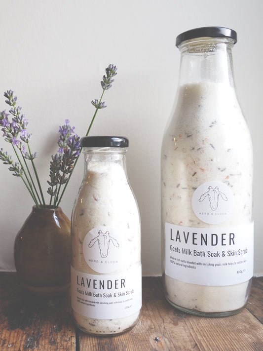 Luxury Goat Milk Bath Salts – Lavender & Botanical Soak with Essential Oils in glass bottles on wooden table.