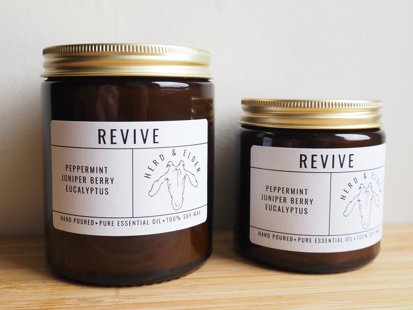 Revive - Essential Oil Eucalyptus, Peppermint & Juniper Berry Soy Wax Candles in amber jars with labels.