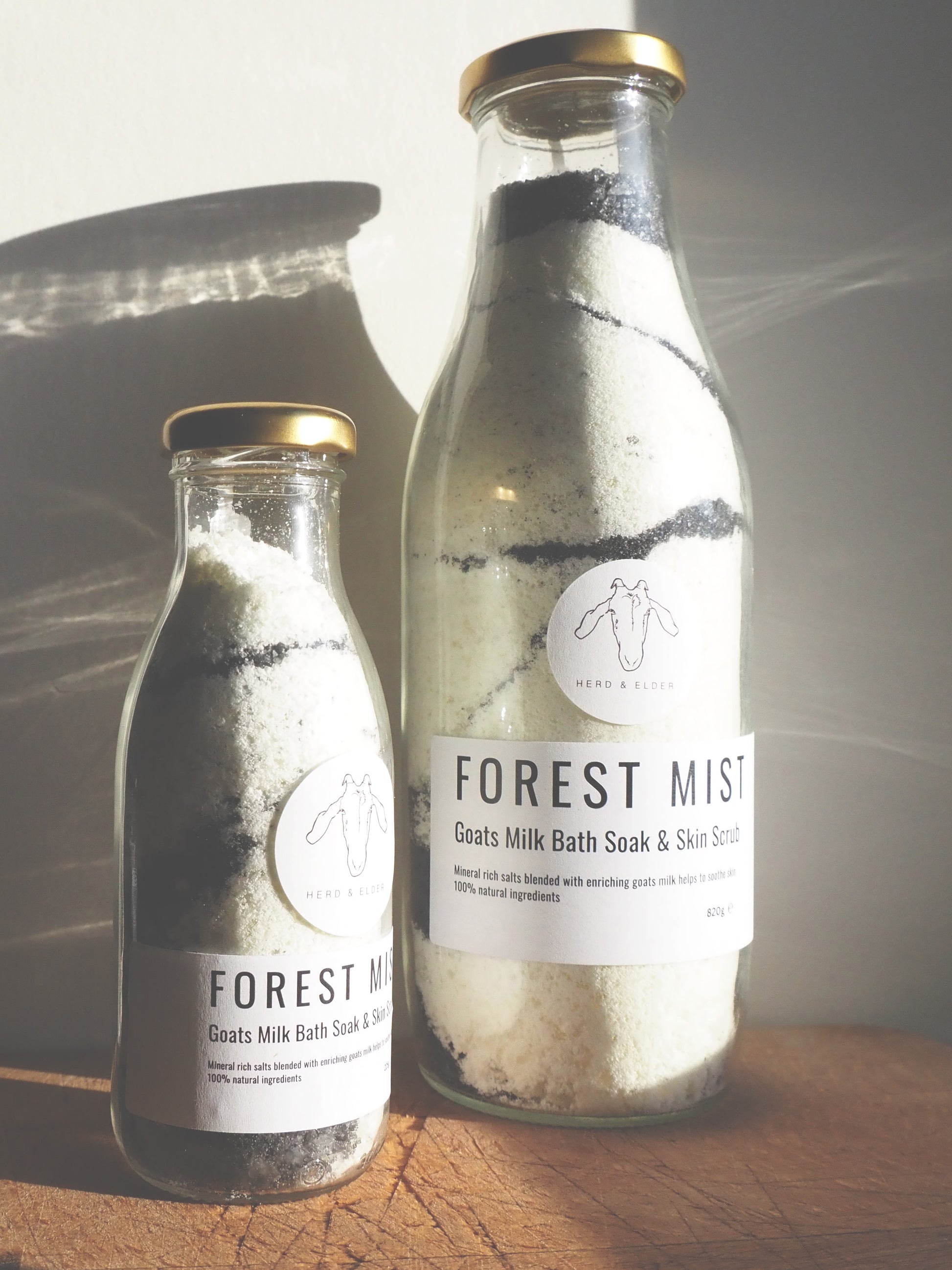 Goat Milk Bath Salts in bottles labeled Forest Mist for soothing and nourishing skin soak and scrub.