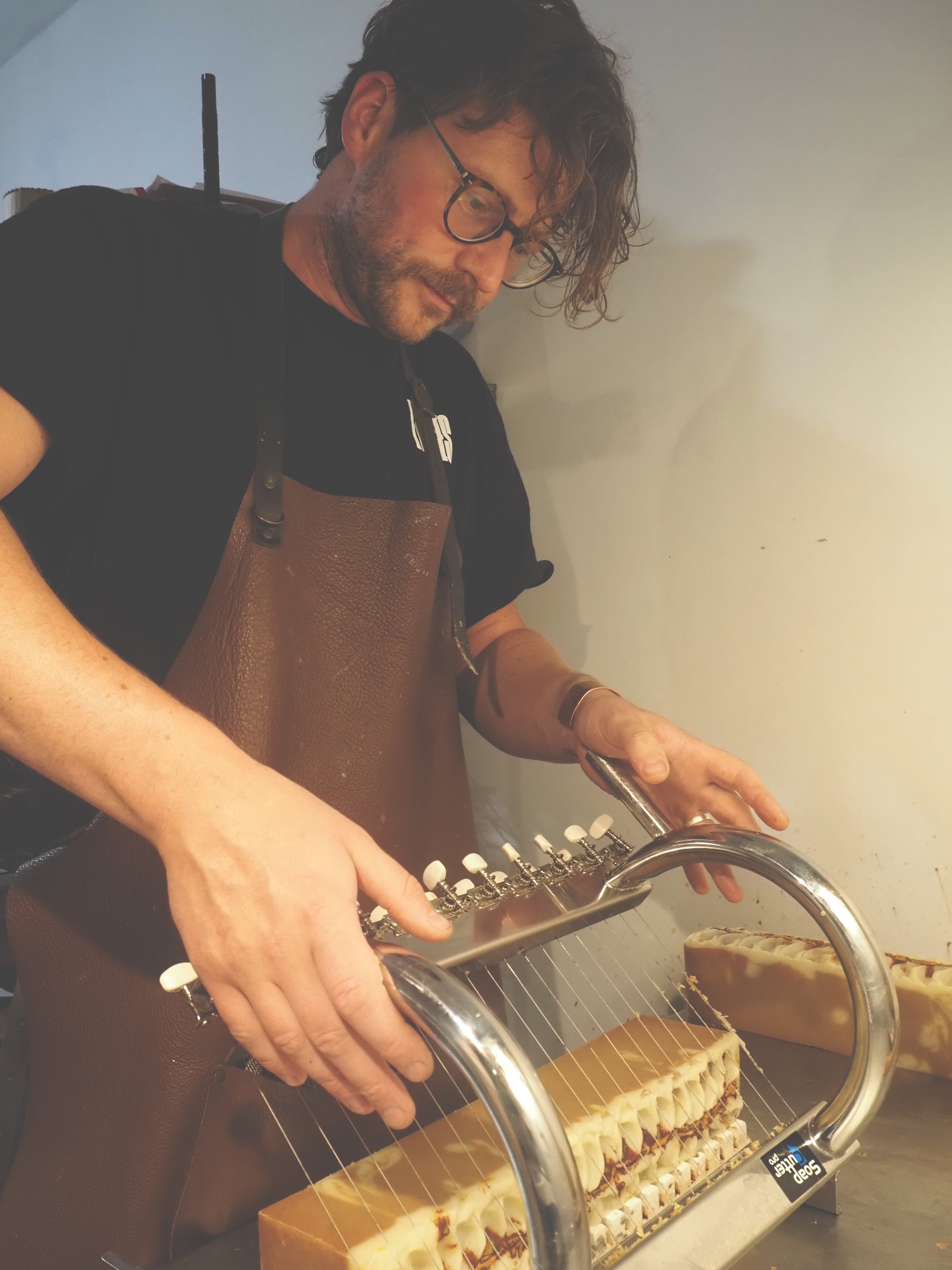 Lavender Goat Milk Soap – Natural, Handmade Cold Process Soap from Lancashire being cut by a soaper in apron.