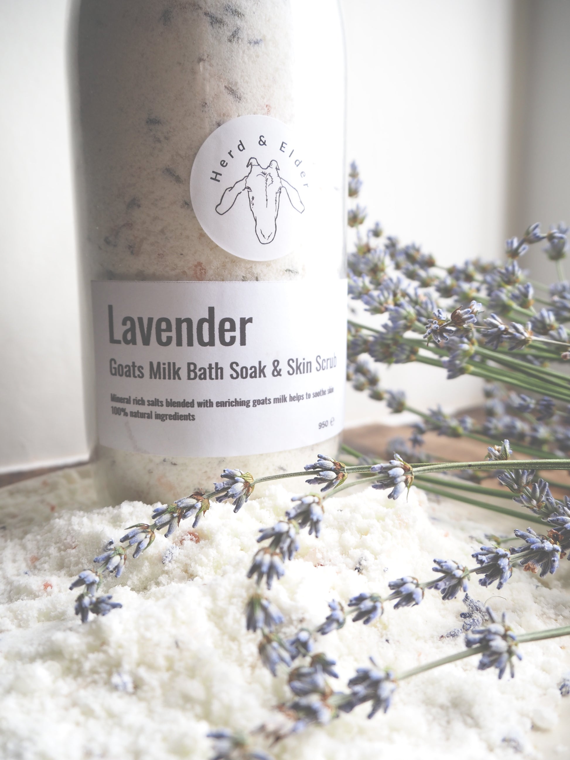 Luxury Goat Milk Bath Salts – Lavender & Botanical Soak with Essential Oils in a glass bottle with lavender flowers.