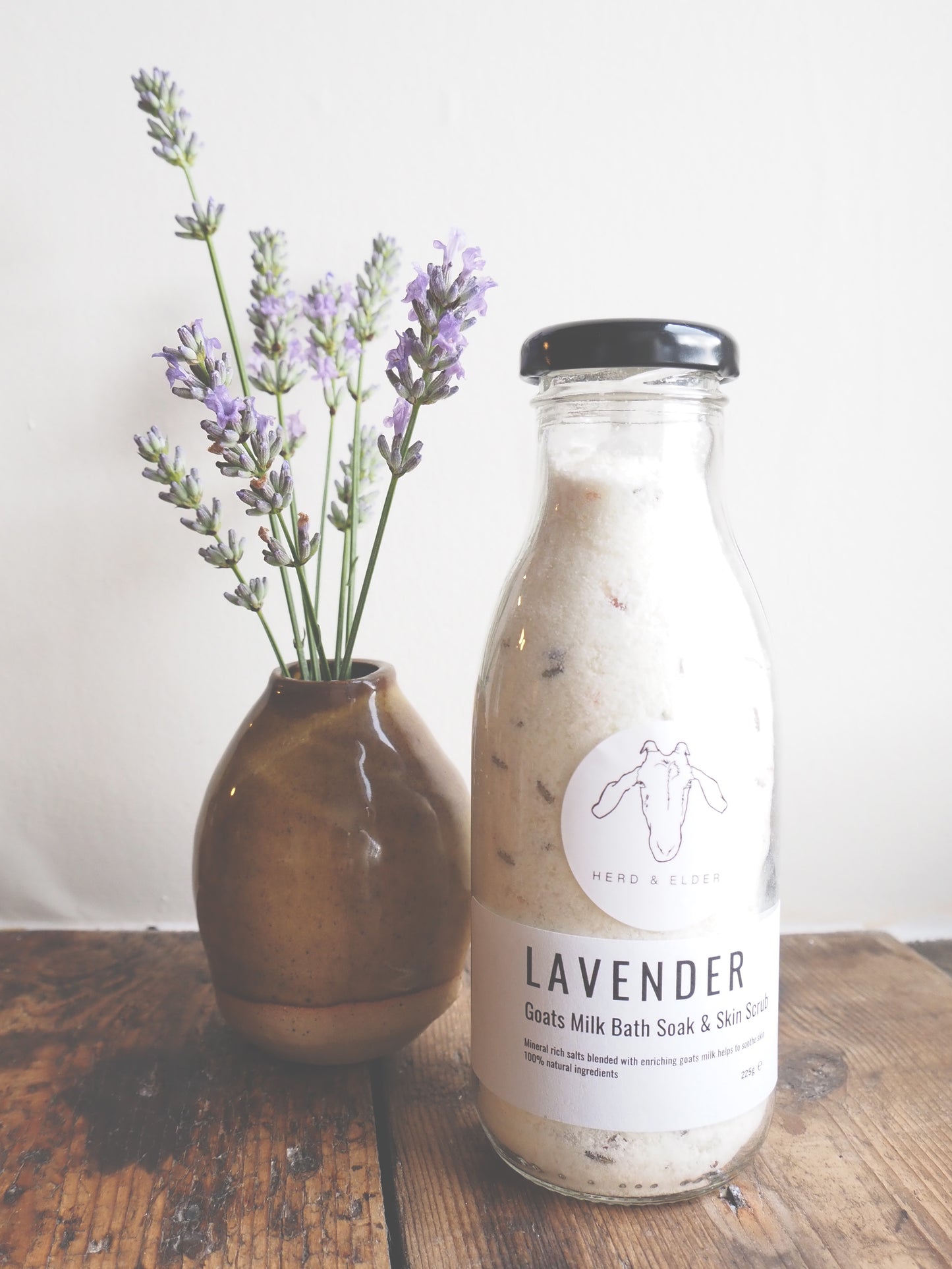 Luxury Goat Milk Bath Salts – Lavender & Botanical Soak with Essential Oils in a glass bottle with lavender flowers.